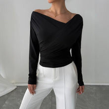 Load image into Gallery viewer, Off shoulder wrap top in black, slim fit chic blouse that works as stylish work wear top, office to evening look, Pinterest trending fall fashion blouse, and brunch ready outfit.