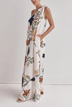Load image into Gallery viewer, floral maxi dress, one shoulder maxi dress, boho maxi dress, flowy maxi dress, long dresses, tie shoulder maxi dress, printed summer dress, Summer vacation dress, Flowy printed dress, earthy floral dress, Vacation-ready outfit, long white dress, summer beach wear outfit 2025, Bohemian one-shoulder maxi dress for beach trips.