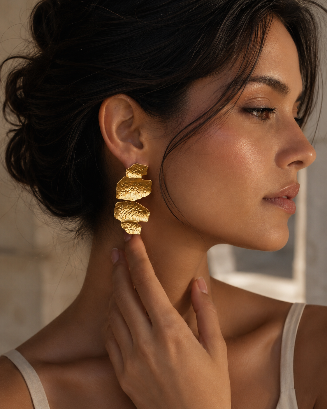Textured gold statement drop earrings with an abstract sculptural shape and hammered finish, creating a bold contemporary accessory that complements linen outfits, tailored workwear, occasion dresses and minimalist wardrobes.