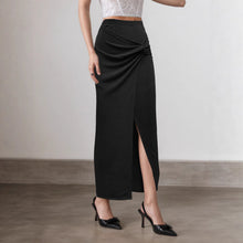 Load image into Gallery viewer, Black and taupe ruched maxi skirt, high slit knot-front style, chic women’s evening skirt for travel, parties, and minimalist wardrobes.