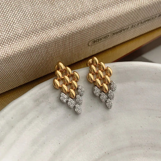 gold drop earrings, Modern gold drop earrings featuring a rhombus geometric silhouette with subtle crystal accents, modern gold earrings, crystal drop earrings, Chic statement earrings for women styled for office wear, cocktail events, evening looks, and special occasions.