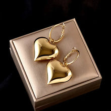 Load image into Gallery viewer, drop heart earrings, gold heart earrings, Asymmetric earrings for women, Quirky earrings for women, Chic earrings for women, Statement earrings, everyday jewelry, Modern fashion earrings, Elegant jewelry for women, Fun fashion jewelry, Women’s statement earrings, Quirky jewelry.