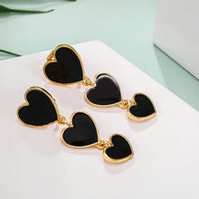 Load image into Gallery viewer, heart earrings, dangle heart shaped earrings, heart shaped clip on earrings, clip on earrings, dangle earrings, drop heart earrings, heart drop earrings, non pierced earrings, jewelry earrings, drop earrings, long earrings, party wear earrings, fun quirky earrings for women, clip on dangle earrings, chanel heart earrings.