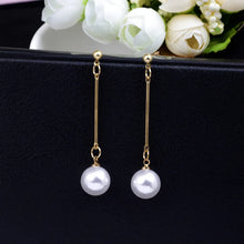 Load image into Gallery viewer, pearl drop earrings, pearl dangle earrings, long pearl earrings, dangle earrings, jewelry for women, earrings for women,  Chic statement jewelry, Unique womenās earrings, Everyday chic earrings.