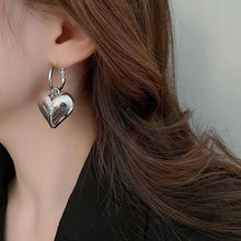 Load image into Gallery viewer, Drop Heart Earrings,  Drop Earrings, heart earrings, dangle heart shaped earrings, womens fashion jewelry, heart drop earrings, Women’s statement earrings, Quirky jewelry, Everyday earrings, Gold and silver earrings, Asymmetric earrings, Chic women’s accessories, Fun fashion accessories, Playful earrings, Chic statement jewelry, Unique women’s earrings, Everyday chic earrings