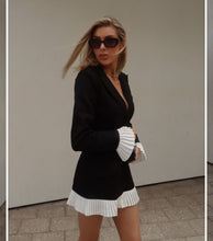 Load image into Gallery viewer, black and white mini dress, black and white blazer dress, pleated mini dress, suit coat dress, suit dress, blazer dress, pleated blazer dress, black mini dress,  Pleated Hem Dress, contrast color dress, Old Money Chic Dress, Black mini dress with white ruffle hem.