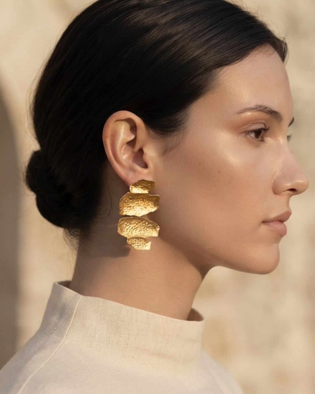 Abstract gold statement earrings with an organic hammered texture and layered drop design in a polished gold-tone finish, perfect for quiet luxury wardrobes, modern fashion, special occasions and contemporary everyday styling.