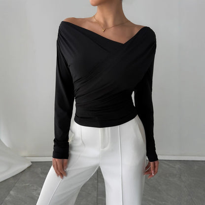 Off shoulder wrap top in black, slim fit chic blouse that works as stylish work wear top, office to evening look, Pinterest trending fall fashion blouse, and brunch ready outfit.