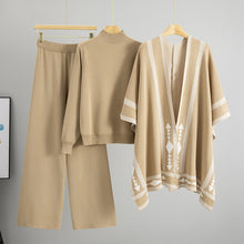 Load image into Gallery viewer, Beige 3 piece knit lounge set for women, 3 piece knit set for women with mock neck sweater, wide-leg knit pants, and poncho chic cozy outfit for travel, dinner, or brunch, knit lounge set women, chic 3 piece outfit, 