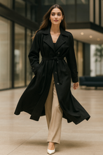 Load image into Gallery viewer, Long black trench coat women, double breasted trench for hourglass figure, Belted trench coat women, oversized trench coat for layering, business casual long trench women, Pinterest trending.