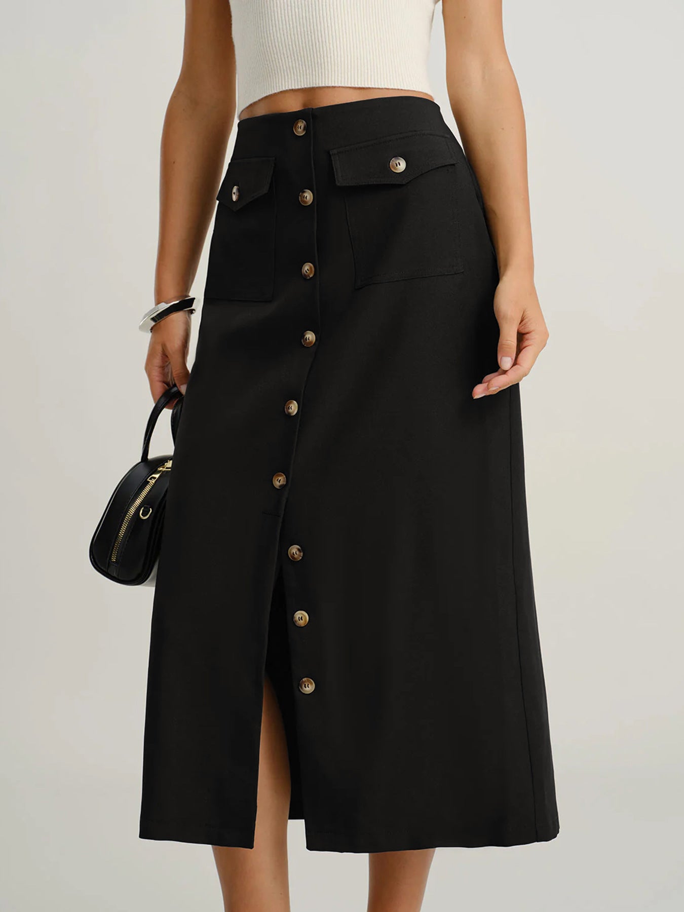 Black midi skirt with slit, business casual skirt, office wear skirt women, tailored woven fabric with front button design and subtle front slit, straight fitted silhouette, black midi skirt with slit outfit women, perfect for smart casual looks, black skirt outfit women, black skirt outfit women, work outfit skirt women.