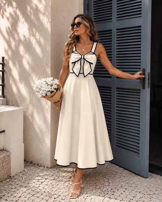 Bow front midi dress with a structured bodice, contrast trim detailing, and a flattering fit and flare silhouette, designed as an elegant summer dress for women seeking timeless feminine style and polished warm-weather outfits.
