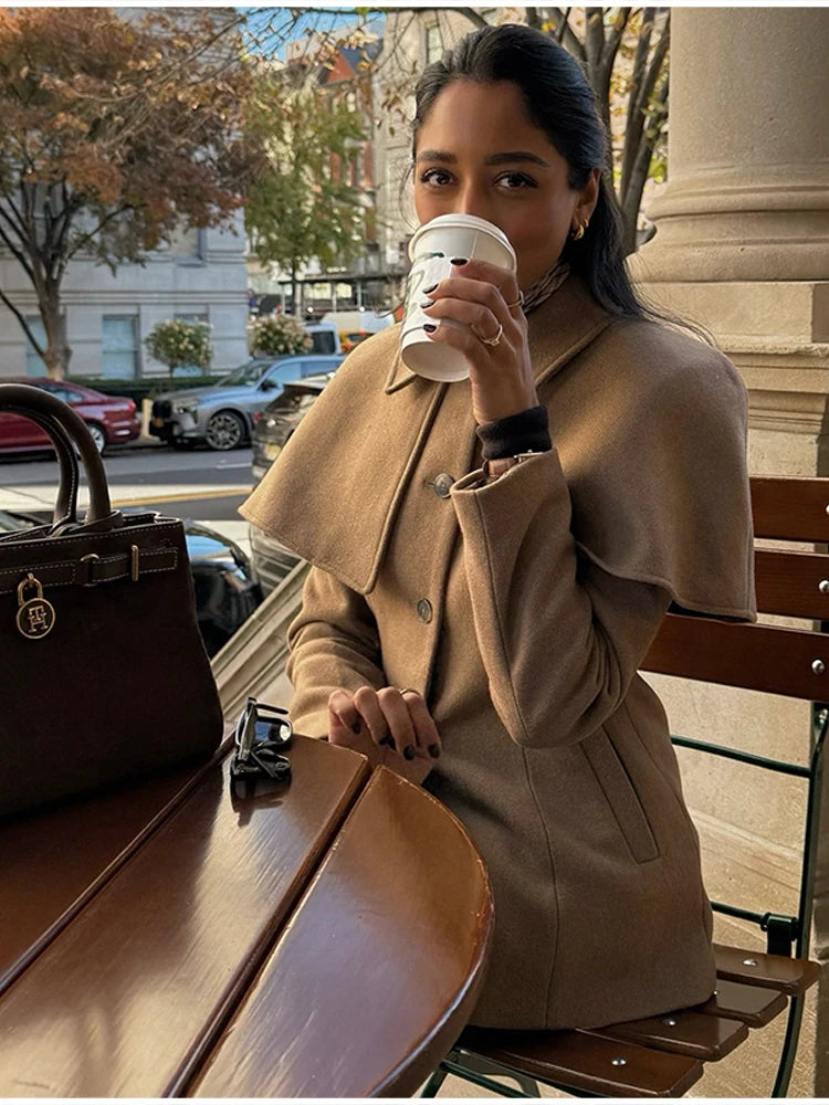 Cape collar jacket women with clean tailoring, hip length tailored jacket, single breasted design, minimalist quiet luxury jacket style suited for business casual and professional office wear.
