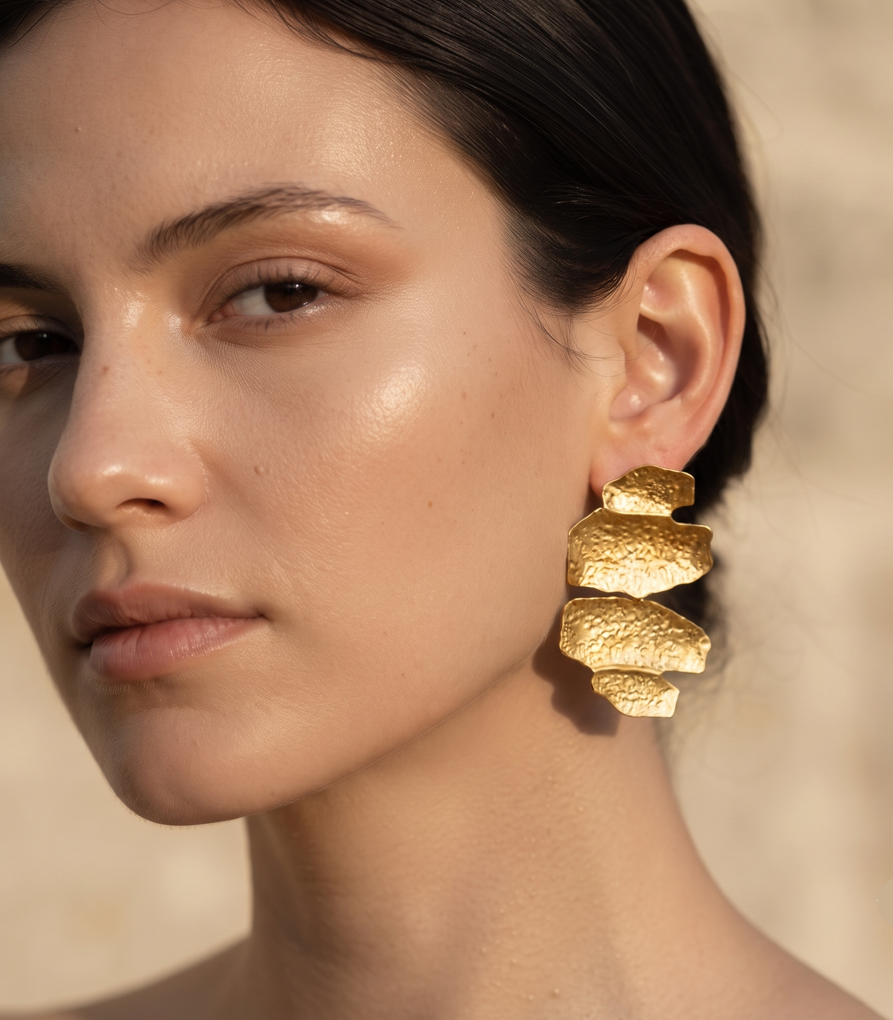 Chunky hammered gold statement drop earrings featuring an abstract layered sculptural silhouette with a textured high-shine gold-tone finish, styled as contemporary designer-inspired jewellery for office wear, weddings, vacations and elevated everyday outfits.