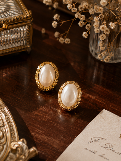 Classic pearl stud earrings for women featuring an oval simulated pearl, polished stainless steel, and premium 18K PVD plating for versatile everyday jewellery and effortless styling.