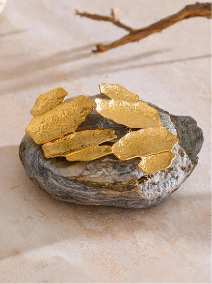 Designer-inspired hammered gold earrings with an artistic layered silhouette and textured gold-tone surface, styled as bold statement jewellery for wedding guests, date nights, capsule wardrobes and contemporary fashion collections.