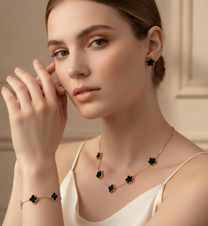 Floral jewelry set with enamel clover charms, glossy stone texture and gold necklace bracelet earrings set styling, refined minimal chain design, elegant clover jewelry set for women, date night accessory, 4 leaf clover necklace bracelet earrings set, enamel jewelry set, gold minimalist jewelry set, dainty gold jewelry set.