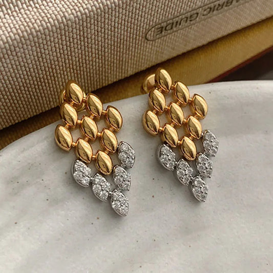 Gold geometric dangle earrings for women featuring a rhombus-shaped drop with crystal stone detailing. elegant drop earrings, chic dangle earrings for women, party earrings women, Lightweight statement earrings ideal for workwear, office outfits, party wear, weddings, and evening looks.