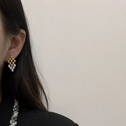Gold geometric dangle earrings for women featuring a rhombus-shaped drop with crystal stone detailing. elegant drop earrings, chic dangle earrings for women, party earrings women, Lightweight statement earrings ideal for workwear, office outfits, party wear, weddings, and evening looks.