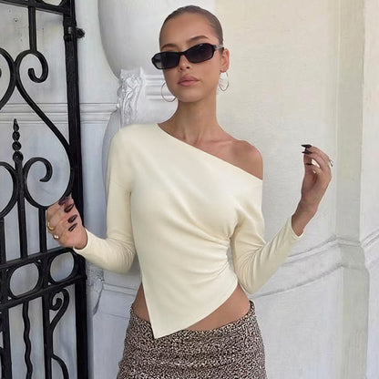Long sleeve asymmetrical blouse, off-shoulder top with sculptural drape, chic date night outfit idea, what to wear for rooftop drinks and transitional autumn fashion.