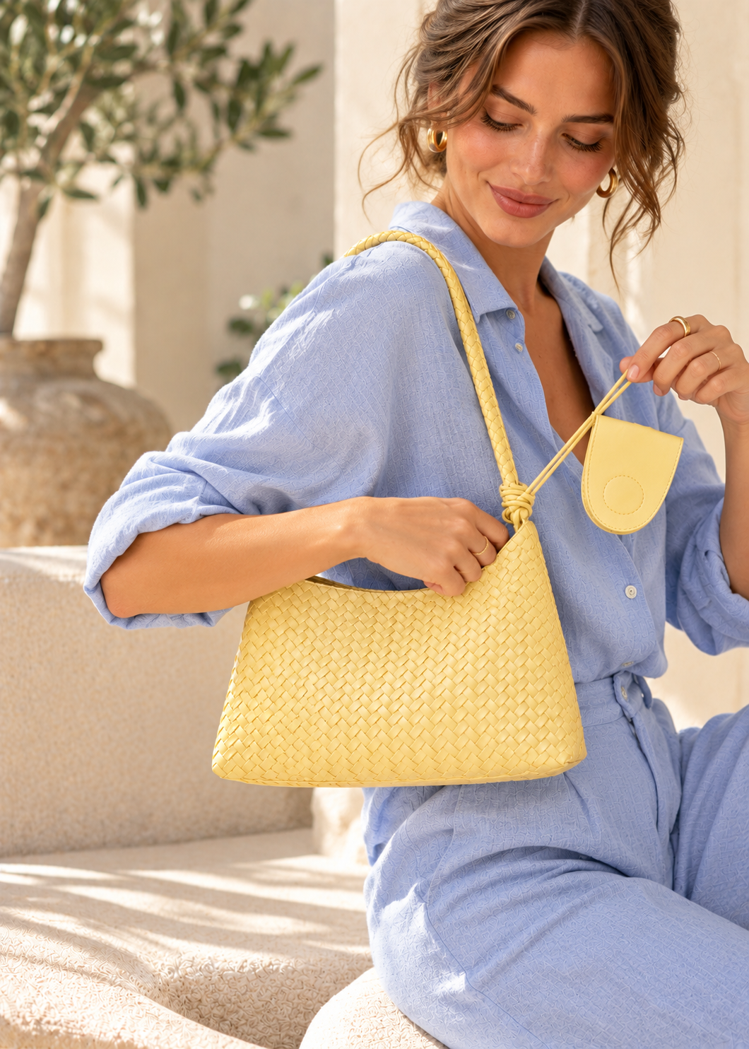 Textured woven shoulder hobo handbag for women with a curved relaxed shape, woven basket construction, long braided shoulder strap and matching zip pouch, designed as a modern shoulder bag for blazers, dresses, workwear and weekend outfits.