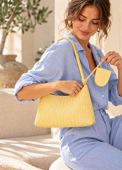 Textured woven shoulder hobo handbag for women with a curved relaxed shape, woven basket construction, long braided shoulder strap and matching zip pouch, designed as a modern shoulder bag for blazers, dresses, workwear and weekend outfits.