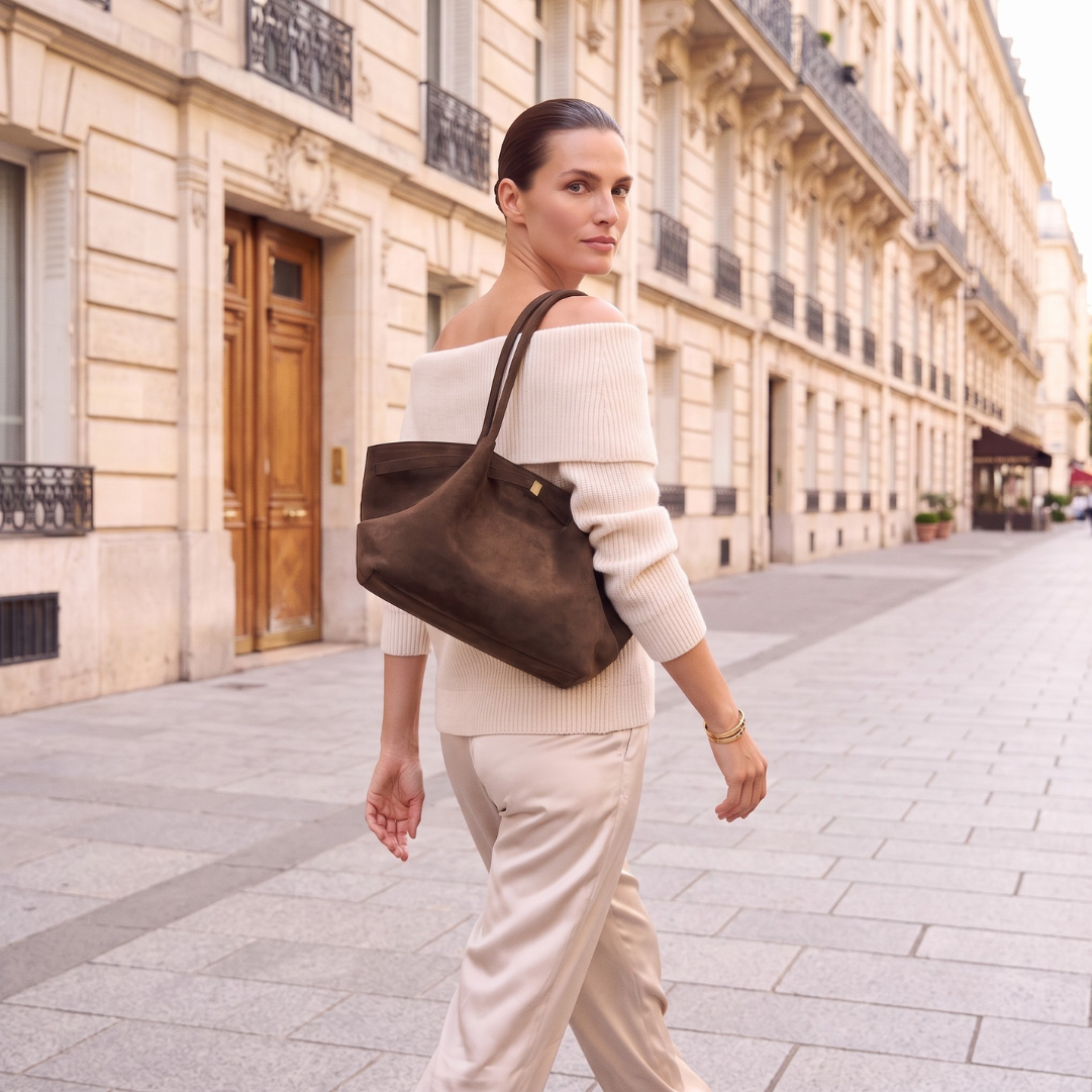 Minimalist tote bag women crafted in faux suede with an oversized slouchy tote silhouette, decorative belted trim, and roomy interior for a stylish minimalist capsule tote wardrobe.