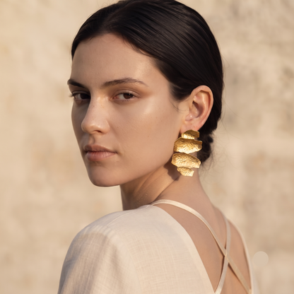 Organic sculptural gold drop earrings featuring a hammered metal texture, layered abstract design and polished gold-tone finish, perfect for European summer styling, quiet luxury outfits and elevated everyday fashion.