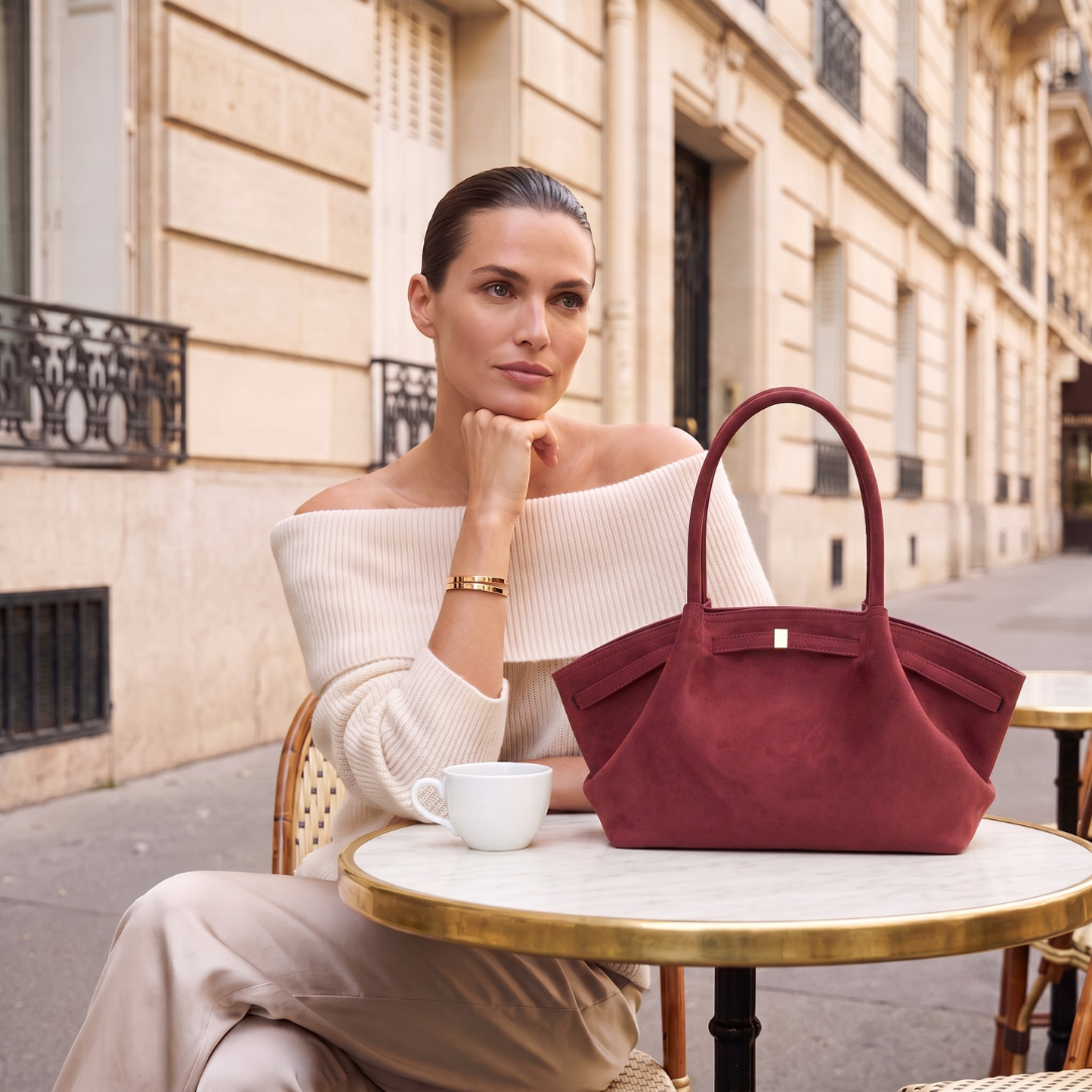 Quiet luxury tote bag with a relaxed shoulder tote bag women silhouette, faux suede texture, belted side trim, and spacious interior, designed for an airport travel tote bag and weekend getaways.
