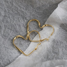 Load image into Gallery viewer, heart hoop earrings, gold heart hoop earrings, quirky earrings, heart drop earrings, heart hoops, Heart earrings, heart dangle earrings, dangle earrings, Quirky earrings for women, Chic earrings for women, Statement earrings, , Modern fashion earrings, Elegant jewelry for women, Fun fashion jewelry, Women’s statement earrings, Quirky jewelry, Chic women’s accessories, Fun fashion accessories, Playful earrings, asymmetrical hearts of love hoop.