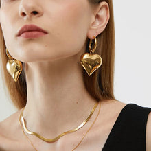 Load image into Gallery viewer, heart drop earrings, Heart earrings, heart dangle earrings, dangle earrings, gold fashion jewelery, huggie hoop earrings, Heart huggie hoop earrings, Chic earrings for women, Statement earrings, everyday jewelry, Modern fashion earrings, Elegant jewelry for women, Fun fashion jewelry, Women’s statement earrings, Quirky jewelry, Everyday earrings, Gold and silver earrings.