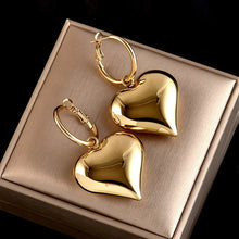 Load image into Gallery viewer, heart drop earrings, Heart earrings, heart dangle earrings, dangle earrings, gold fashion jewelery, huggie hoop earrings, Heart huggie hoop earrings, Quirky jewelry, Everyday earrings, Gold and silver earrings, Asymmetric earrings, Chic women’s accessories, Fun fashion accessories, Playful earrings, Chic statement jewelry, Unique women’s earrings, Everyday chic earrings.