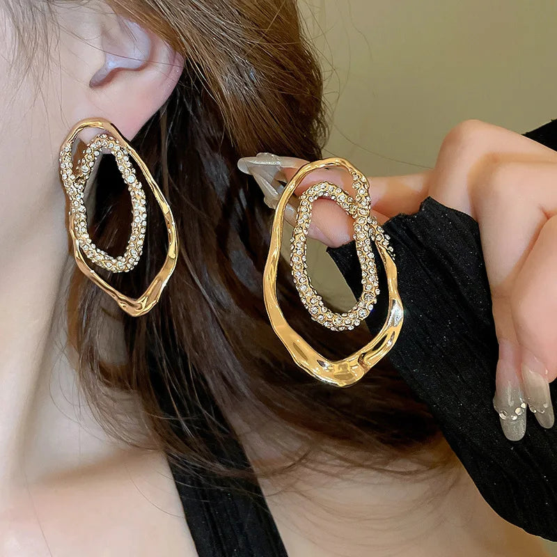 Sculptural gold and silver double-oval earrings with pavé crystal detailing, lightweight statement drop earrings for women, U.S. fashion jewelry accessory.