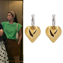 Load image into Gallery viewer, heart drop earrings, Heart earrings, heart dangle earrings, dangle earrings, gold fashion jewelery, huggie hoop earrings, Heart huggie hoop earrings, Asymmetric earrings for women, Quirky earrings for women, Chic earrings for women, Statement earrings, everyday jewelry, Modern fashion earrings, Elegant jewelry for women, Playful earrings, Chic statement jewelry, Unique women’s earrings, Everyday chic