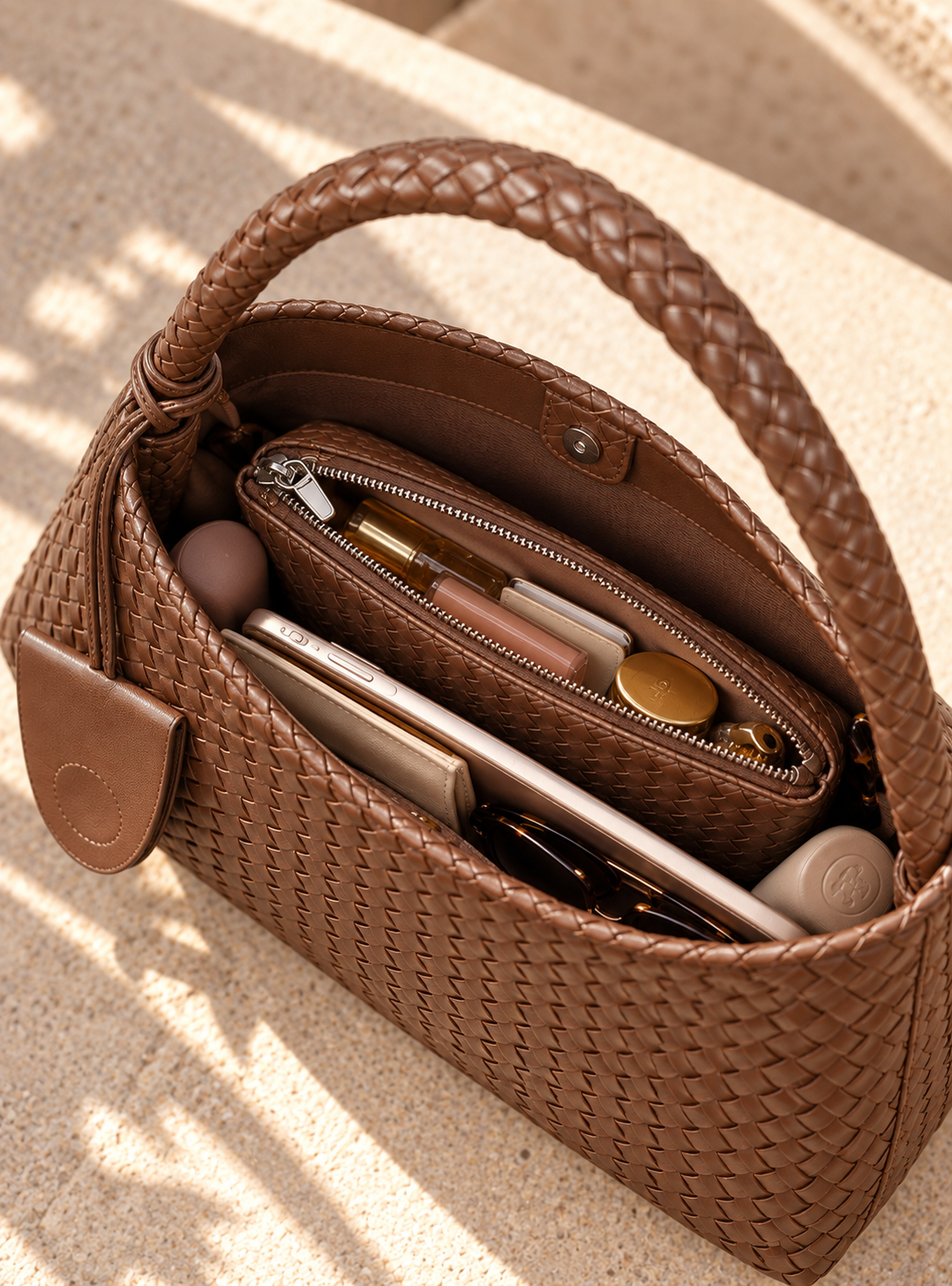 Woven brown handbag for women with a relaxed hobo silhouette, tactile basket weave pattern and braided shoulder strap, finished with a matching zip pouch as a distinctive textured accessory for everyday outfits, office looks and travel.