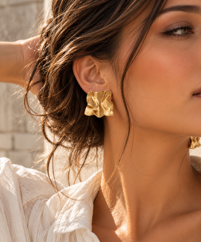 Gold geometric stud earrings for women with a bold square silhouette, flowing wave contours and textured stainless steel construction, combining modern sculptural jewelry with polished statement accessories for brunch and dinner dates.