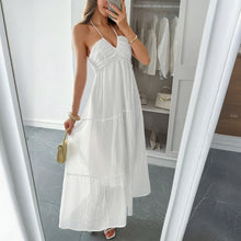 Load image into Gallery viewer, White Boho maxi dress styled with statement earrings and a woven beach bag – perfect for summer travel outfit ideas.