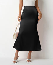 Load image into Gallery viewer, Women’s satin slip midi skirt in neutral and bold shades. Elegant versatile skirt styled with blouses for office workwear, camis for date nights &amp; satin skirts trending on Pinterest in 2025.
