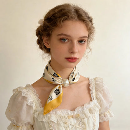 Women's magnetic neck scarf in a printed faux silk fabric with an elegant pearl closure, creating a stylish no-tie fashion accessory for everyday wear and gifting.