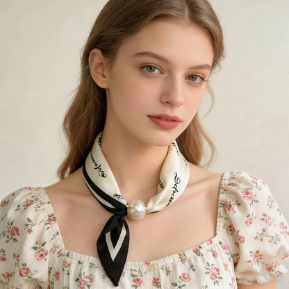Women's printed scarf necklace with a soft silk-feel texture, decorative pearl clasp, and lightweight construction, designed as a modern no-tie neck scarf. black and white printed neck scarf for women.
