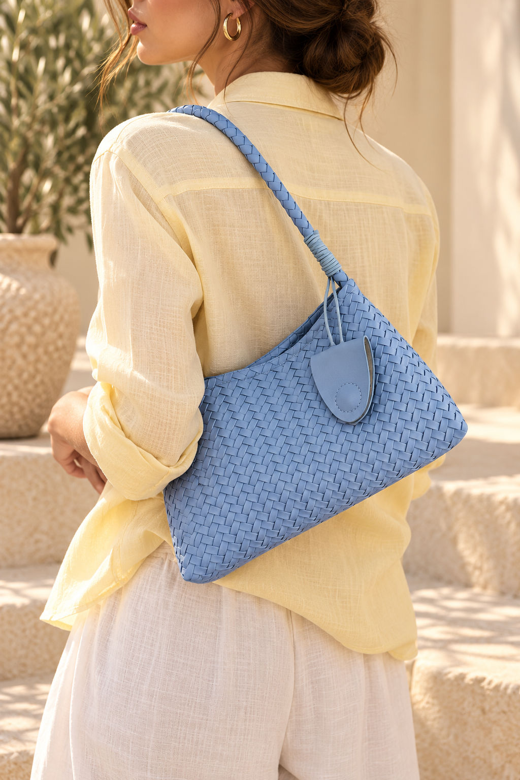 Woven blue yellow faux leather handbag for women with a relaxed hobo silhouette, tactile basket weave pattern and braided shoulder strap, finished with a matching zip pouch as a distinctive textured accessory for everyday outfits, office looks and travel.