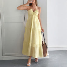 Load image into Gallery viewer, Yellow boho maxi tiered layers and halterneck straps on model – romantic and airy for beach vacations. Beautiful tiered maxi dress makes it perfect maxi for summer.