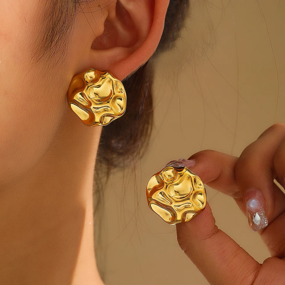 statement stud earrings, gold stud earrings, textured gold earrings, Sculptural gold statement stud earrings with an abstract textured metal finish, chunky modern design, bold fashion jewelry for women, perfect for workwear, evening outfits, and minimalist luxury looks.