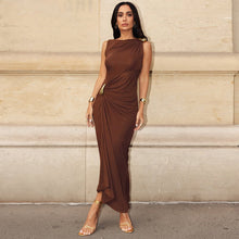 Load image into Gallery viewer, pleated draped maxi dress, Chocolate brown draped maxi dress for women featuring a gold ring detail, asymmetric hem, and elegant boat neckline, a quiet luxury formal gown for weddings or galas, asymmetric evening dress women, gold ring detail maxi dress, draped formal gown women, cocktail party brown dress women.