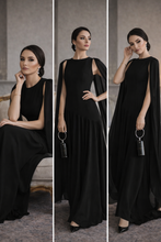 Load image into Gallery viewer, A line skirt gown, black chiffon cape sleeve maxi dress for women featuring flowing A-line silhouette and structured bodice, formal evening gown designed for wedding guests, cocktail receptions, and special events, ruched waist maxi dress, Diagonal asymmetric waist seam ruched texture.