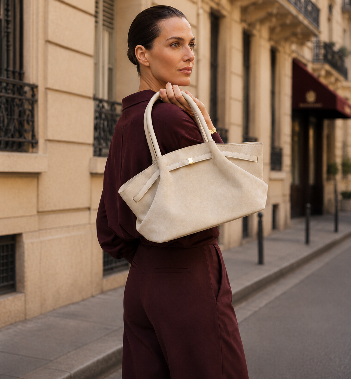 Faux suede tote bag with an oversized slouchy tote silhouette, decorative belted trim, gold-tone hardware, and spacious interior, styled as an office work tote bag for everyday professional carry.
