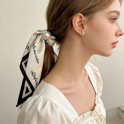 Printed faux silk scarf with a magnetic pearl fastening, perfect for travel wardrobes, European vacations, weekend brunches, and lightweight resort-inspired accessorizing.