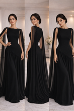 Load image into Gallery viewer, Fit and flare evening gown, red cape ruched maxi dress, evening gown with cape, asymmetric cape dress, Black chiffon cape sleeve maxi dress for women featuring flowing A-line silhouette and structured bodice, elegant Valentine’s Day evening gown for formal date nights and special occasions.