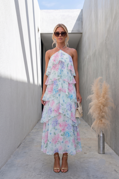 tiered A-line floral maxi dress, halter open back tiered maxi dress, Watercolor floral dress with flowing A-line silhouette and open-back tie closure, romantic maxi dress perfect for boho wedding guest dress styling and vacation-ready elegance, blue floral spring wedding maxi, cascading tiered ruffle maxi dress.