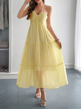 Load image into Gallery viewer, Flowy boho maxi dress in motion – halter neckline and tiered hem styled for beach vacation or resort brunch. The plunging v neck with noodle straps add the extra oomph to this gorgeous summer sundress.